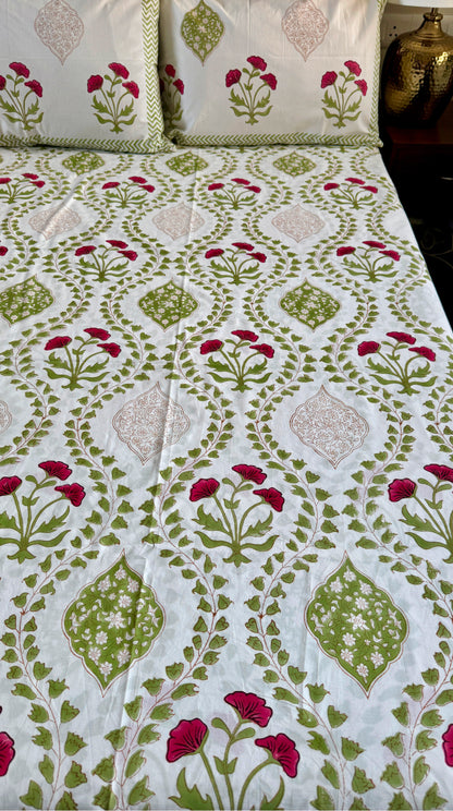 Green red premium cotton bedsheet for warm and festive bedroom styling by Aenak